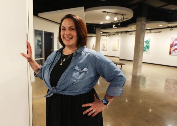 A photograph of arts administrator Meghan Bias standing in a gallery.