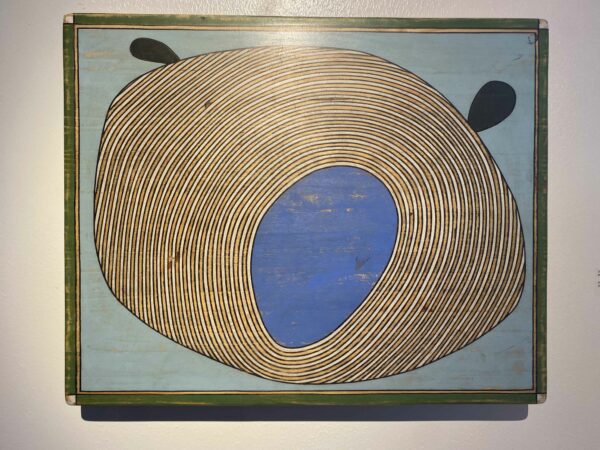 Painting of gold and yellow concentric circles with a blue center