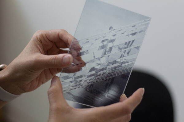 Samira Yamin holds a vinyl photographic print on acrylic in her studio