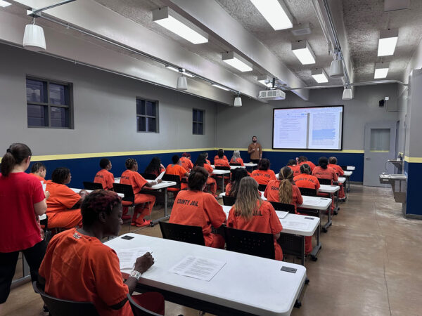 A photograph of a classroom of incarcerated women.