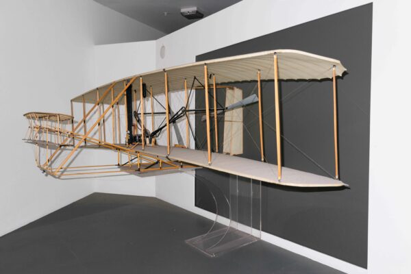 Photo of a maquette of a plane against a gray wall