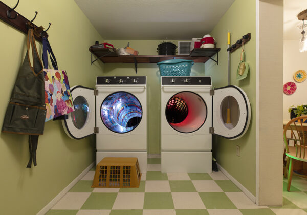 Photo of an installation of a laundry room of a home with two portals inside the washer and dryer