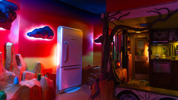Installation image of a refrigerator door in the middle of a wall in a technicolor room