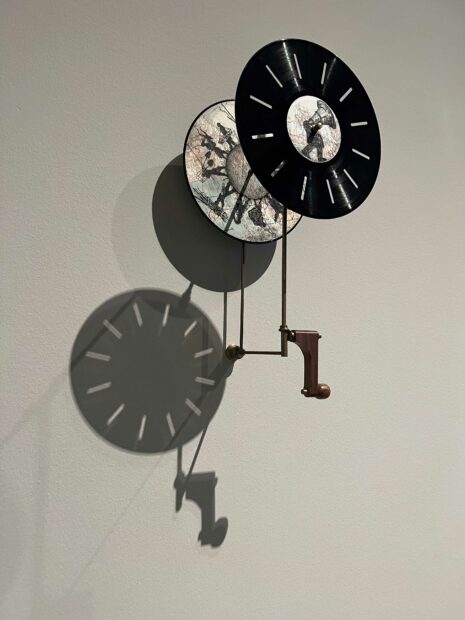 Round kinetic sculpture on a white wall