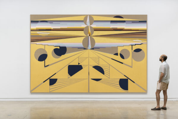 Large scale abstract painting of brown and black shapes on a yellowish backgroundon a white wall