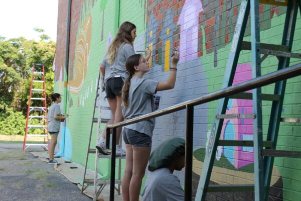 Image of students painting a mural