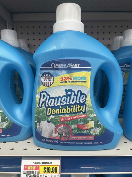 Installation image of a detergent bottle titled "Plausible Deniability"