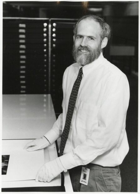 A black and white photograph of curator John Rohrbach from 1996.