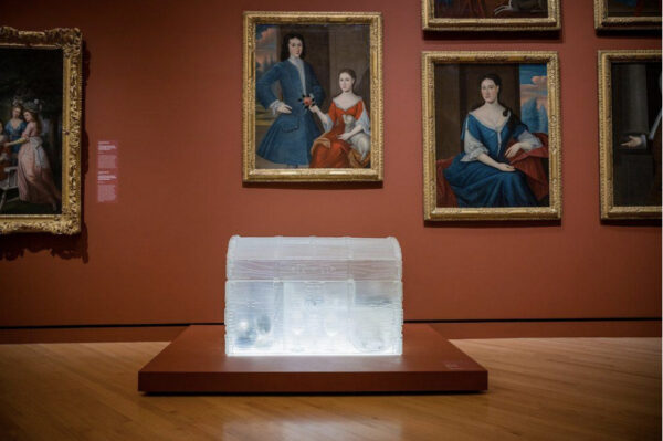 Ice sculpture in a gallery with classical portraits