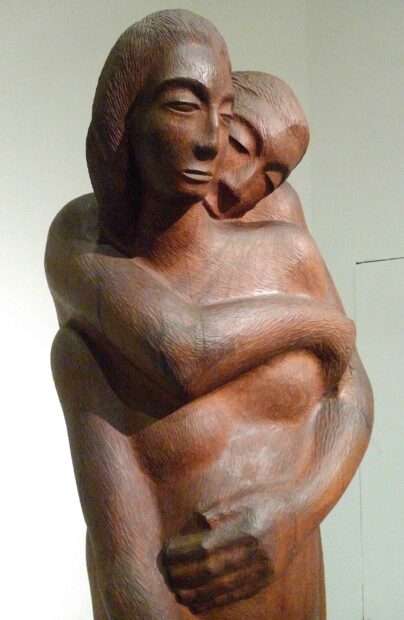 Photo of a sculpture of a couple, the man with his arms around a woman