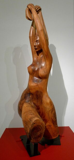 Wood sculpture of a woman bather