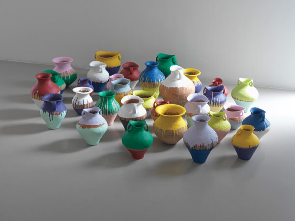 A photograph of a series of ancient vases that have been painted with vivid colors. Artwork by Ai Weiwei.