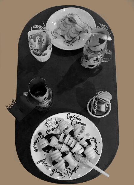 Dorama looking piece of a picnic table wiith plates and glasses made of paper and ceramic
