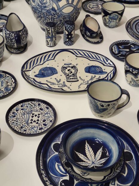 Details of ceramic dishes with images of marijuana leaves, pills, and a deck of cards