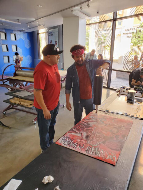 Image of the artists Francisco Delgado and Marco Sanches working on a print