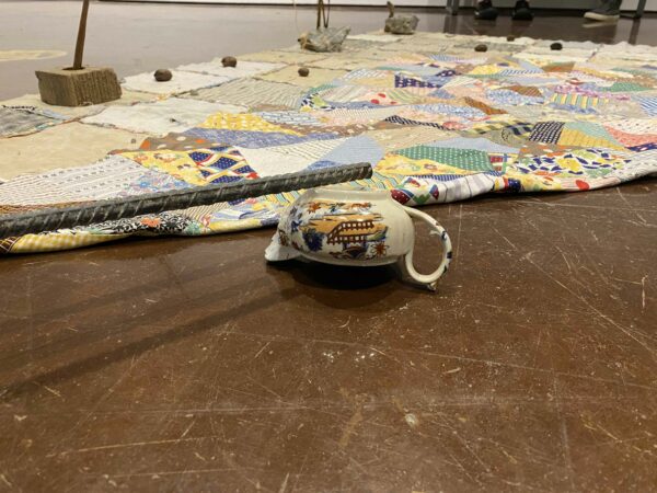 Detail of an upside down teapot and aa blanket