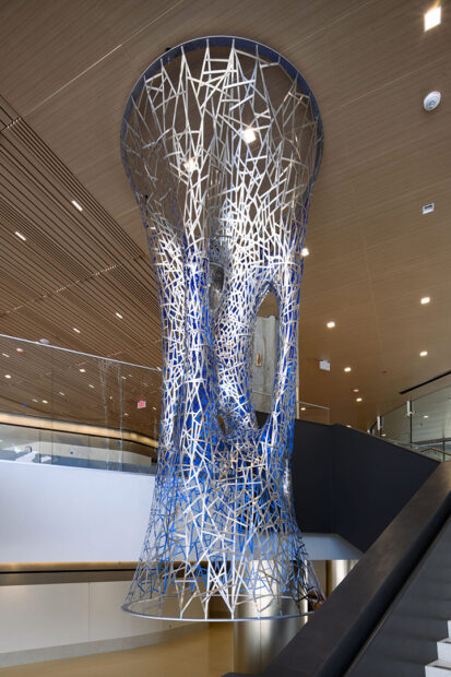 A photograph of a suspended public art sculpture in a hospital lobby.