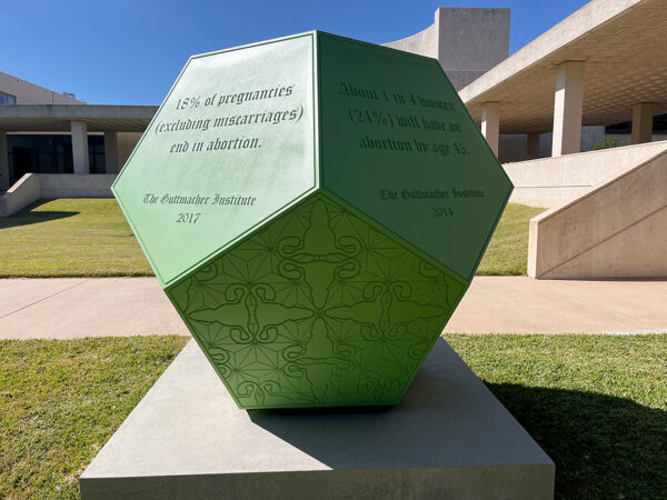 A large sculpture by Sarah Ayala with text about abortion statistics.