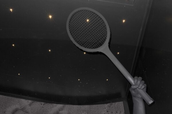 Photo of a mannequin holding aa tennis racket