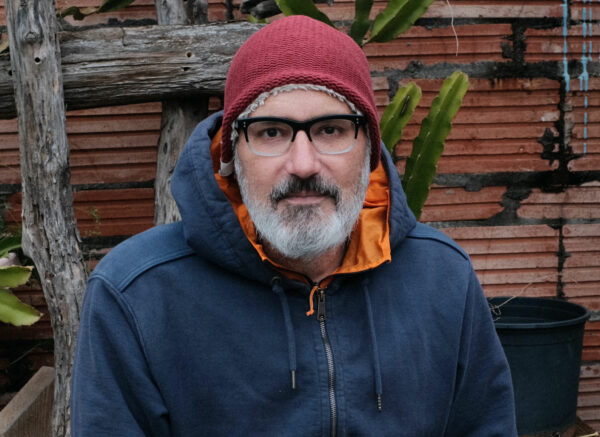 A photographic portrait of a white man dressed in winter wear.