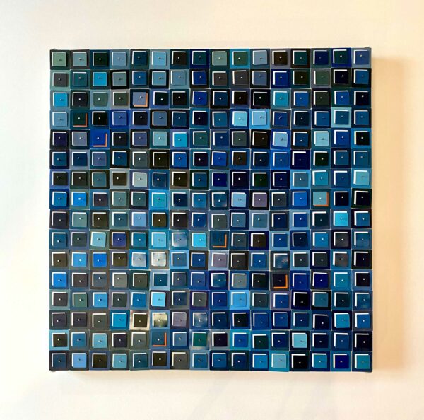An artwork featuring a collage of paint swatches, all nailed to a canvas.