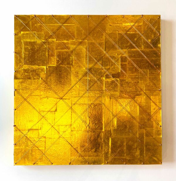 An artwork featuring a golden ground made of joss paper. Wire crisscrosses above the paper in a geometric pattern.