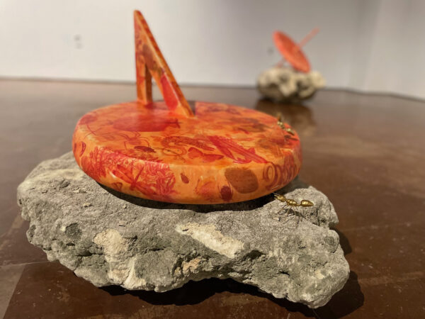 Installation photo of a sundial on a rock