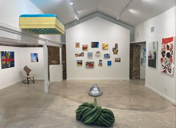 An installation photograph showing a wide range of artworks that are part of an exhibition called "House Party" featuring still lifes in a variety of media.