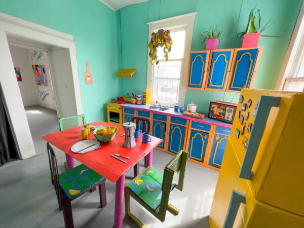 Installation view of a technicolor cardboard kitchen
