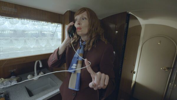 Video still of a woman talking on a telephone