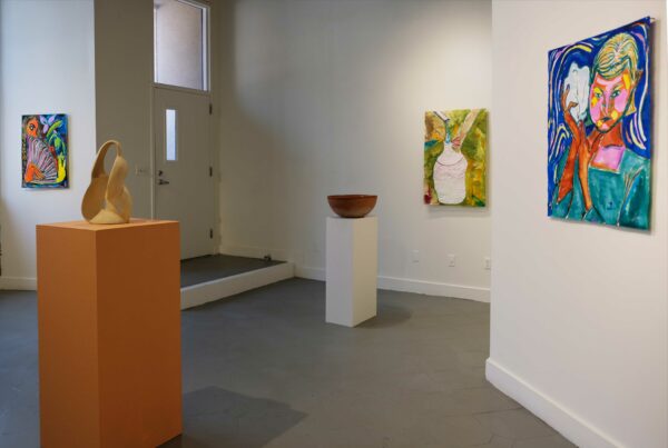 Installation photo of ceramic vessels on pedestals and ink drawings on paper in a gallery space
