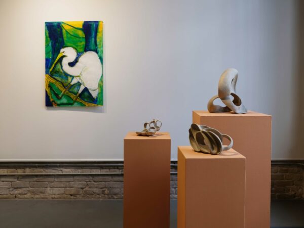 Install imaged of a painting with a crane and three ceramic vessels on pedestals