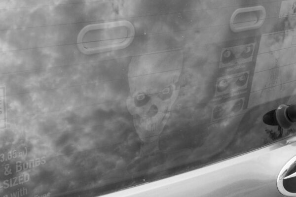 Reflection of a skeleton in a car window
