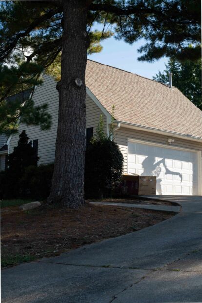 Photo of a house with a skeleton shadow on the garage door