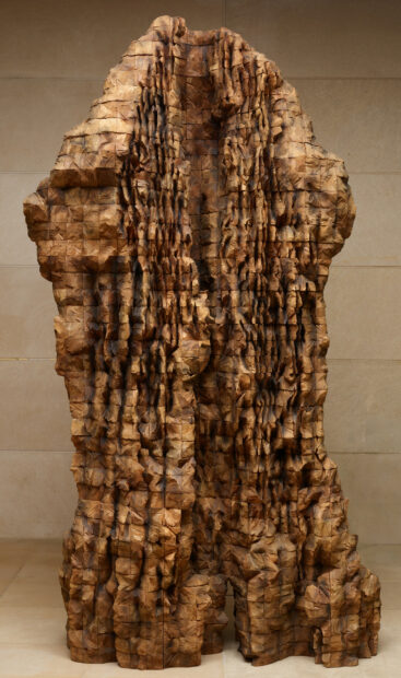 A photograph of a large scale wood sculpture by Ursula von Rydingsyard.