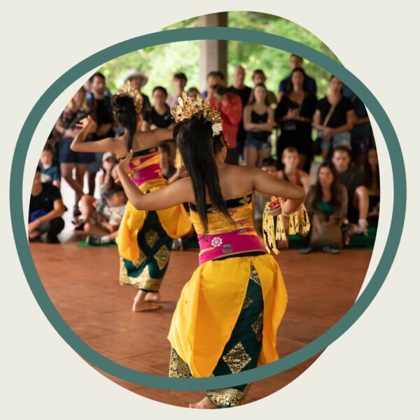 A photograph of a dance group performing in front of an audience.