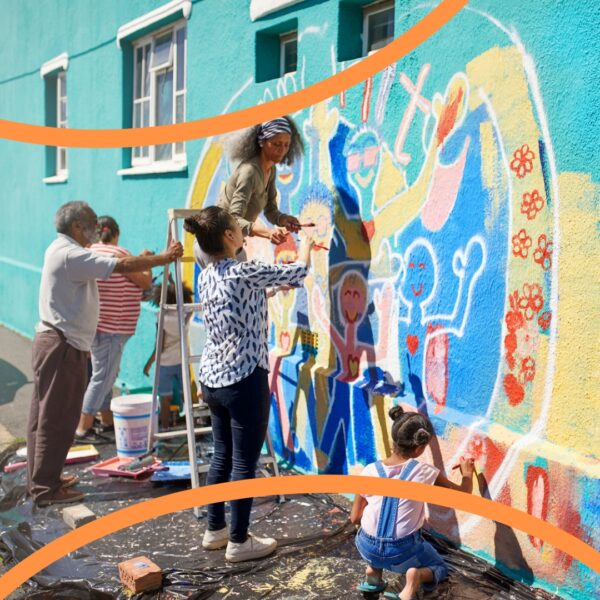 A photograph of a group of people painting a mural.