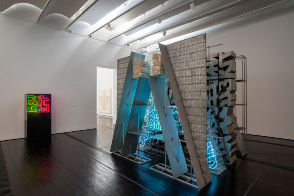 Installation view of a sculpture with steel, aluminum, and neon