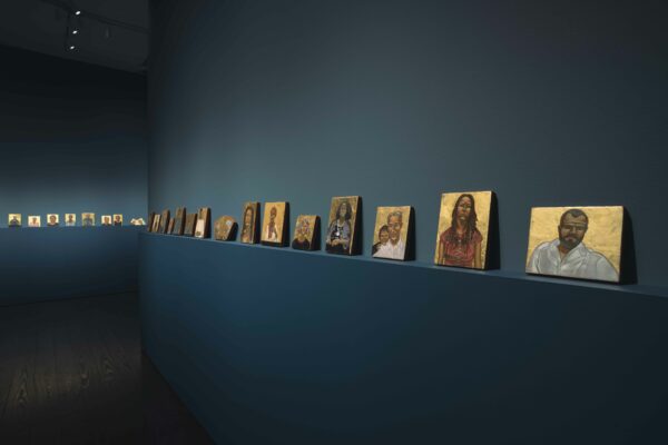 Installation view of small format portraits on a shelf