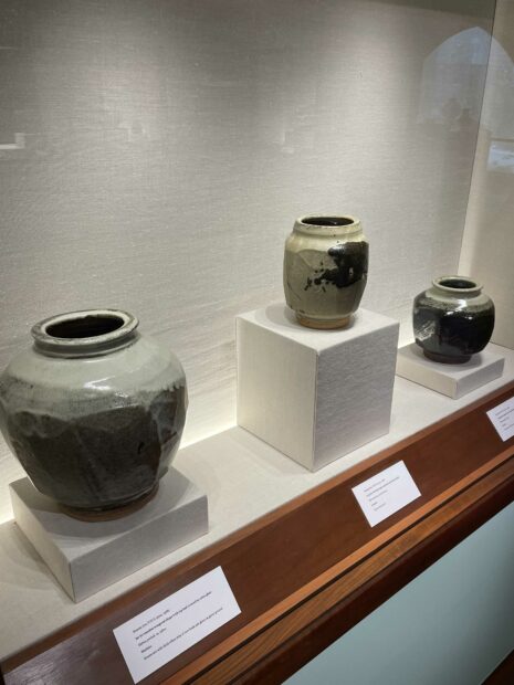 Ceramic jars on view in a vitrine
