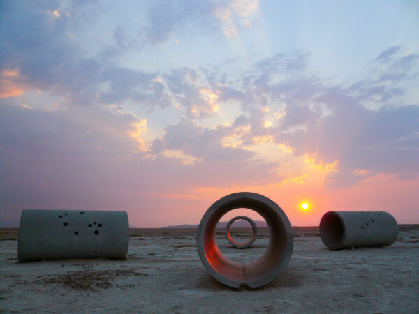 Photo of a land art piece made of culverts at sunset