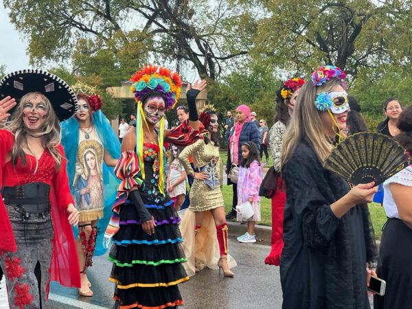 People walking in a day of the dead parade