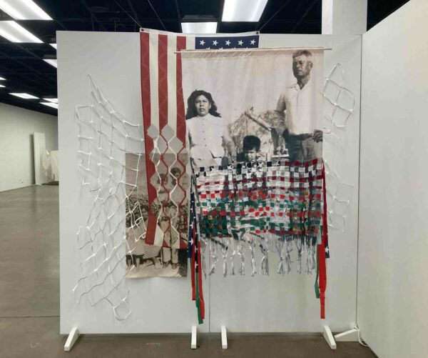 Tina B. Medina, “sacrificios por una patria/ sacrifices for a homeland,” 2023 Photo on canvas and fabric, flags, paper, thread, 96 x 96 x 24 inches