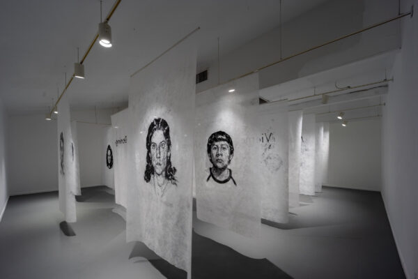 Installation view of portraits on fabric