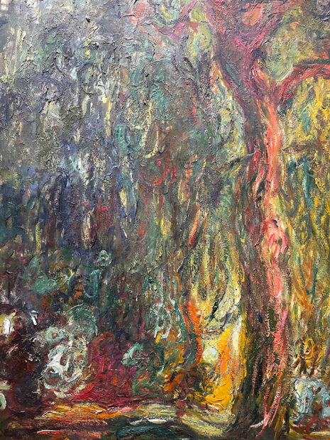 A close-up photograph of a detail from a painting by Claude Monet of a willow tree.