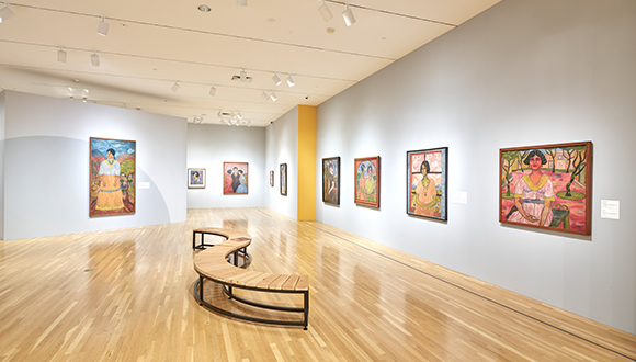Installation view of portrait paintings on a wall