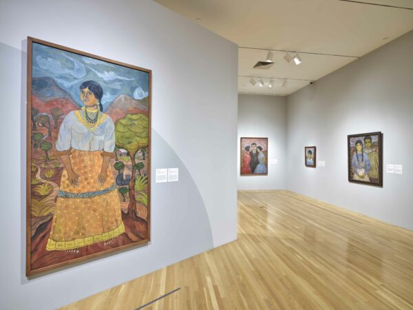 Installation view of large scale portrait paintings in a gallery
