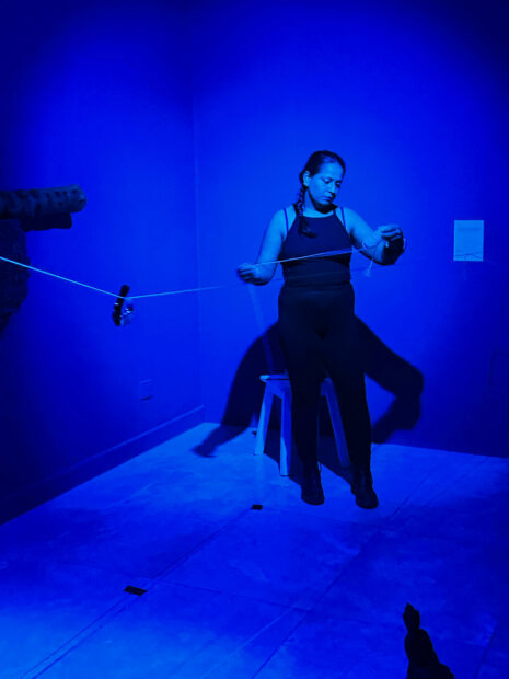 Photo of an artist performance in a blue room