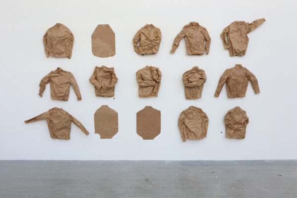 Installation image of crumpled shirts made of paper
