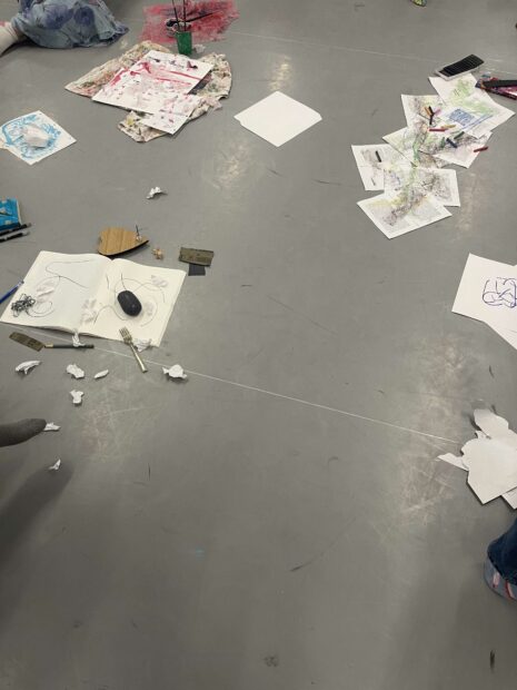 Image of papers and supplies on the floor for a workshop